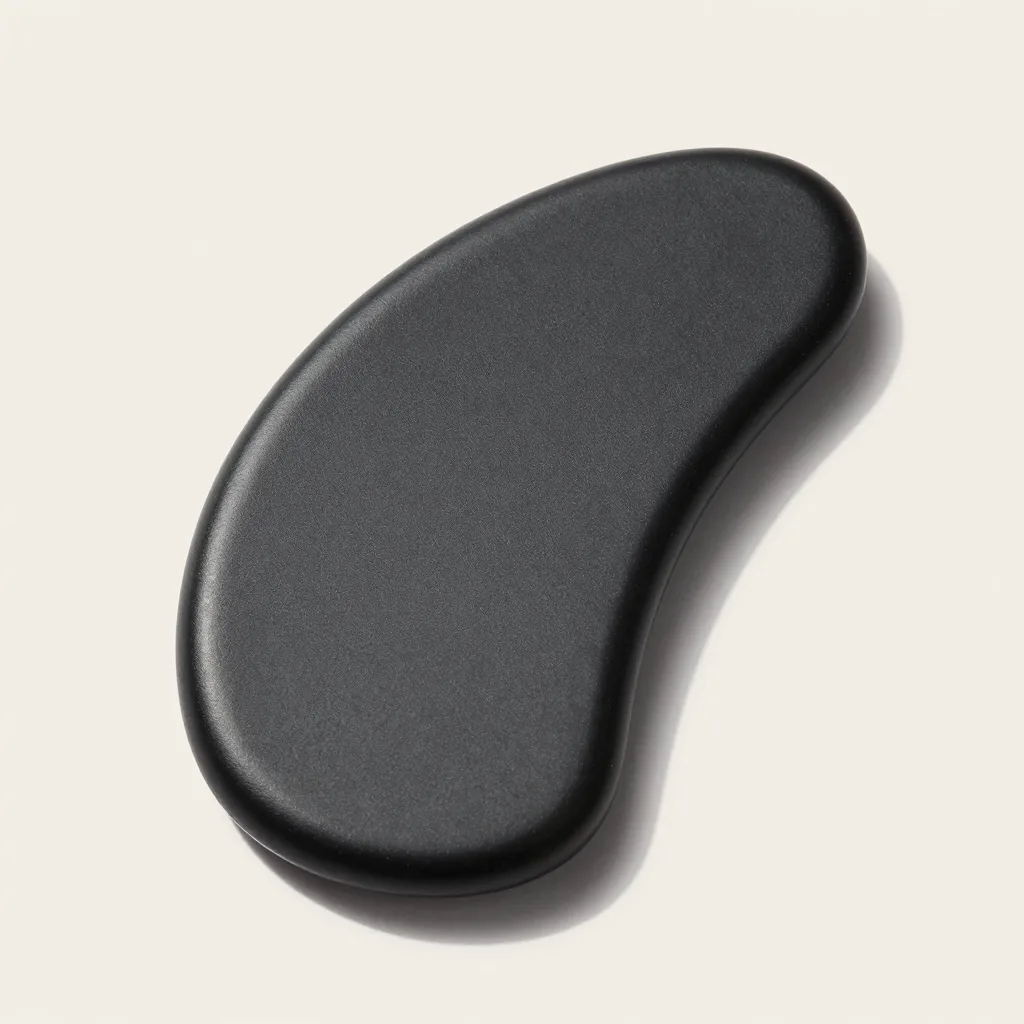 A small pocket-sized obsidian gua sha board